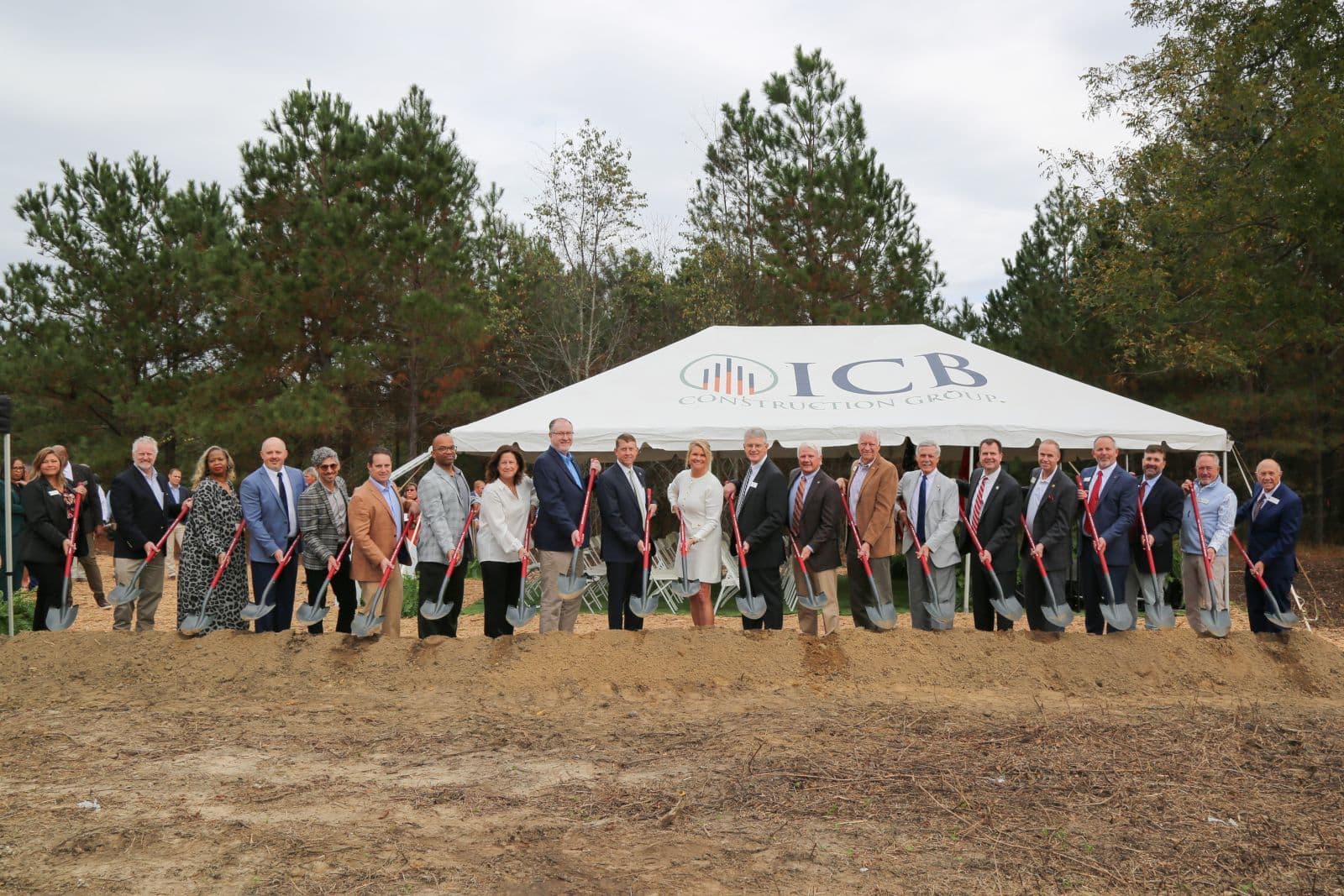 OTC leaders and officials break ground with ceremonial shovels at the site of the new Industrial Systems & Robotics facility.